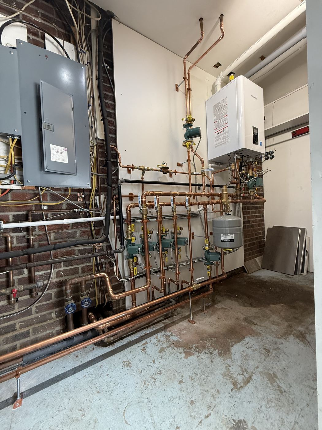 Boiler room with wall-hung boiler and copper zone manifold