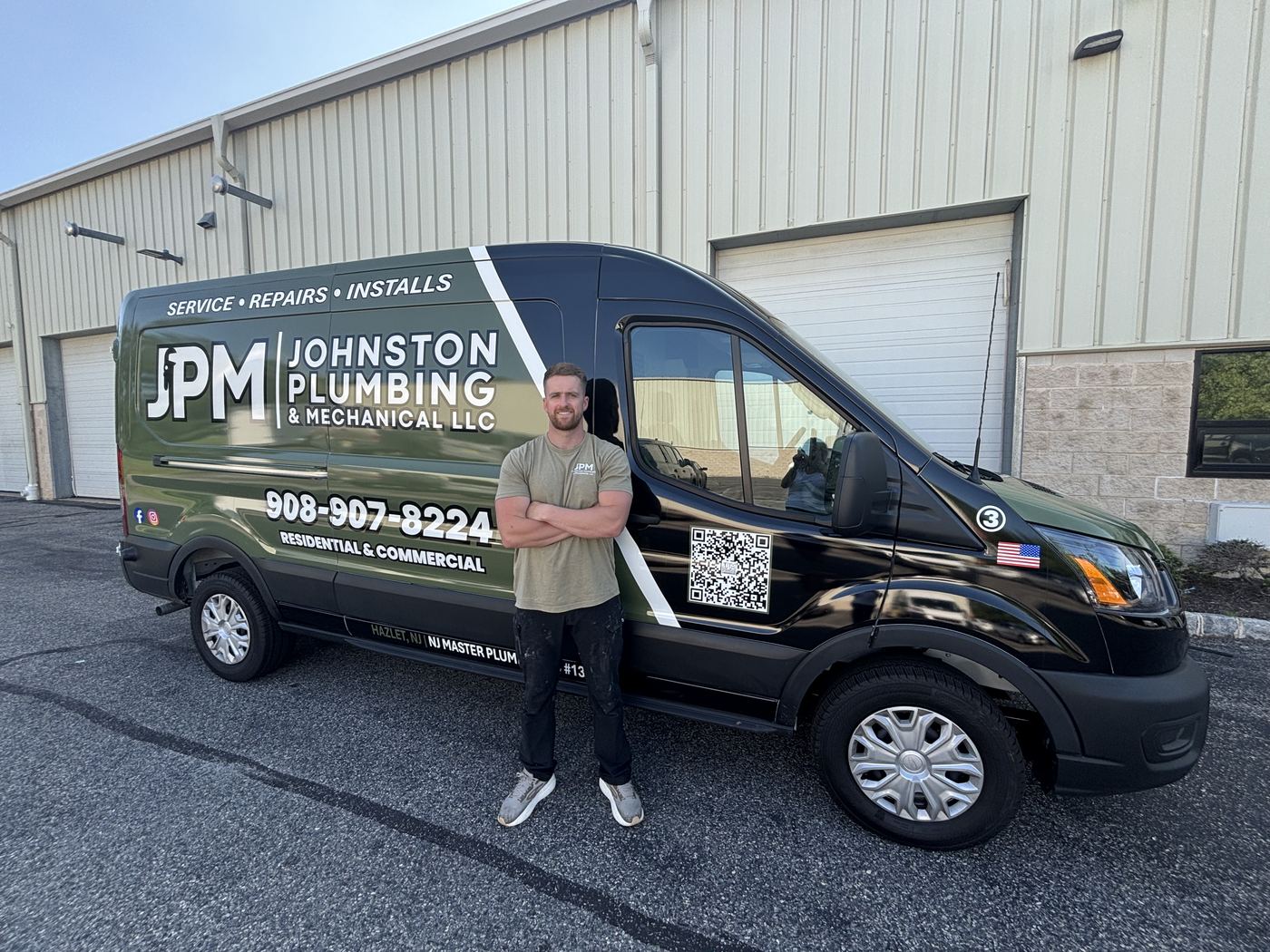Chris Johnston, owner of Johnston Plumbing & Mechanical, standing beside the JPM van