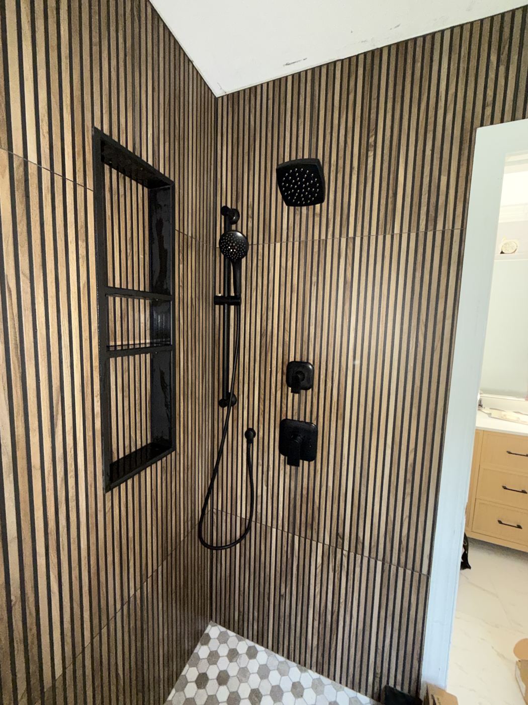 Walk-in shower with matte black fixtures