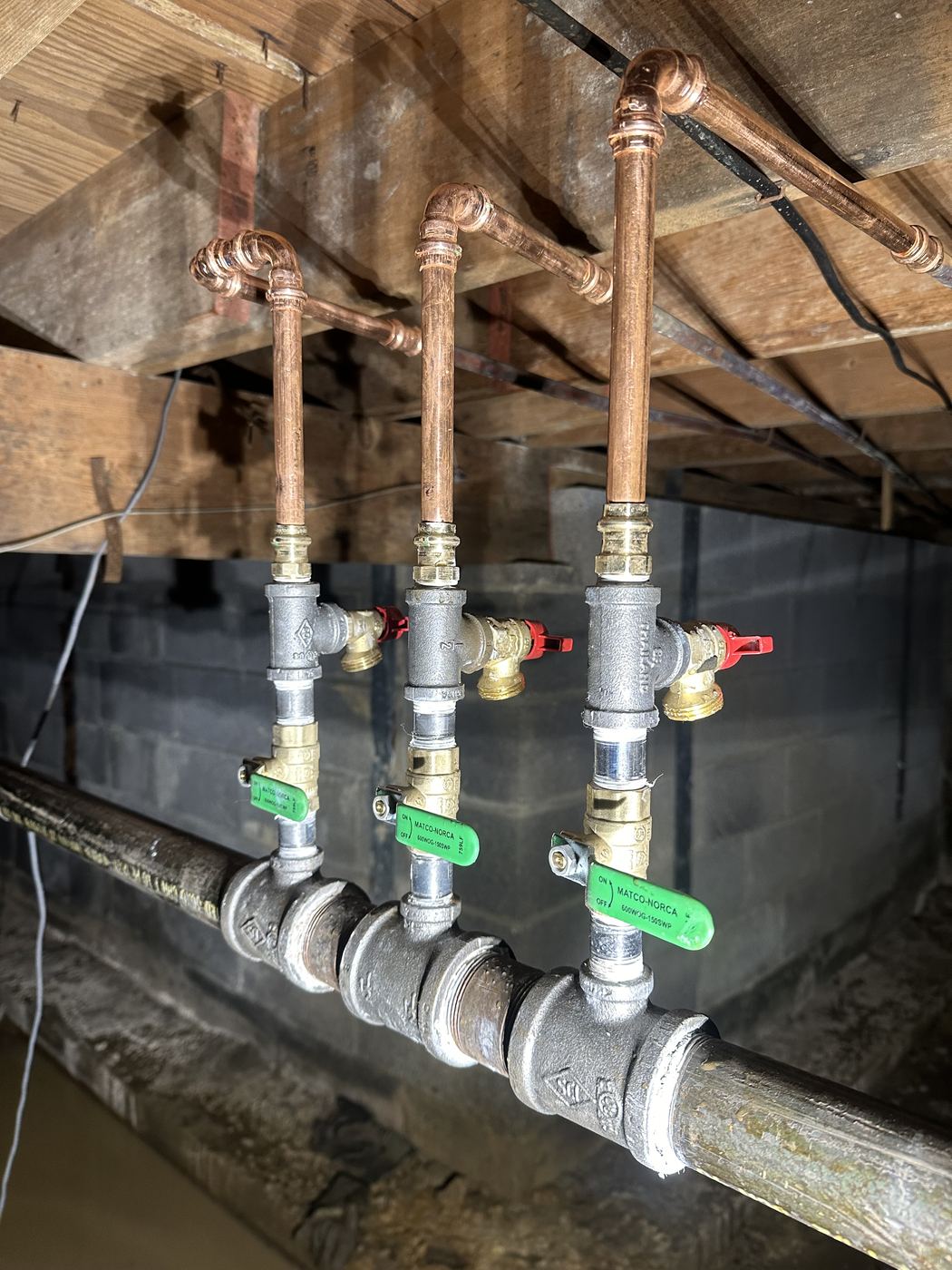 New copper water branches with shutoff valves in a crawl space